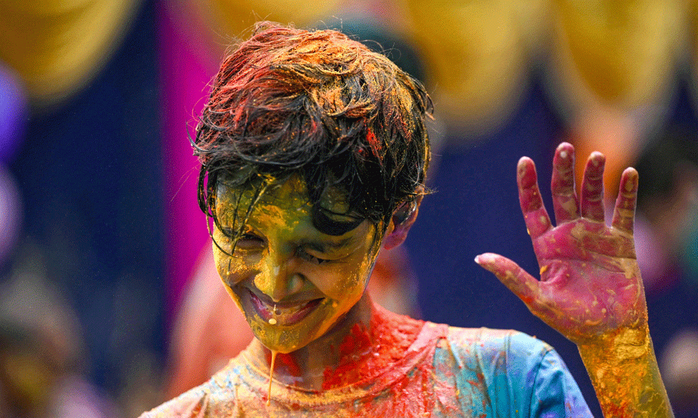 A boy is smeared with ‘Gulal' as he celebrates Holi, the Hindu spring festival of colours, in Chennai on March 25, 2024. Photo : AFP