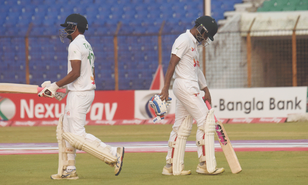 Bangladesh’s Taijul Islam (L) and Mahmudul Hasan Joy (R) walk between the wickets during the second day of the second Test cricket match between Bangladesh and Sri Lanka at the Zahur Ahmed Chowdhury Stadium in Chittagong on March 31, 2024. Photo : Rafiqur Rahman Raqu