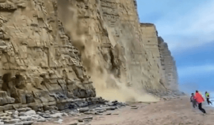 Tourists narrowly escape as crumbling cliff smashes into UK beach