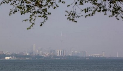Orange wildfire haze blankets North America cities