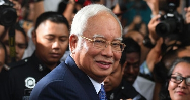 Malaysia halves ex-PM Najib’s jail term